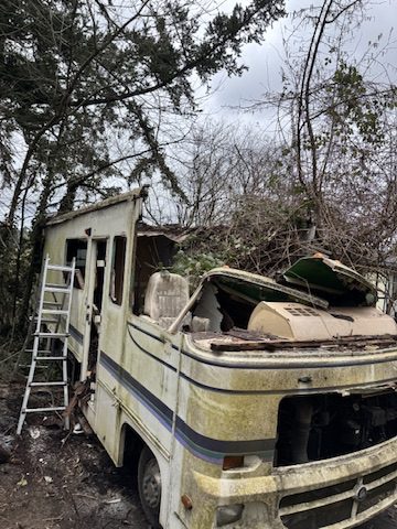 Class A motorhome mid-demolition showing hand dismantling process in Portland