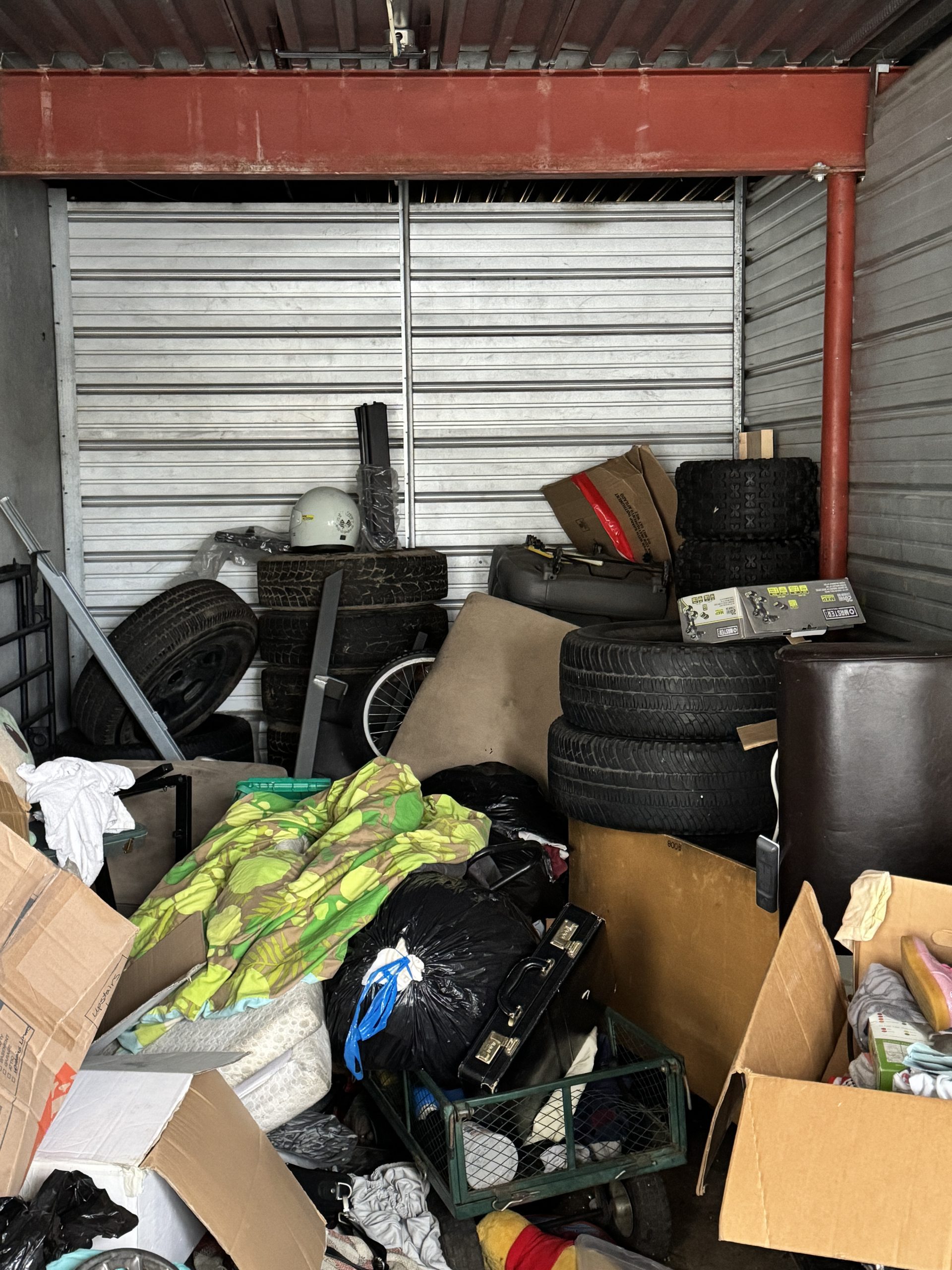 Packed storage unit with furniture and boxes ready for cleanout